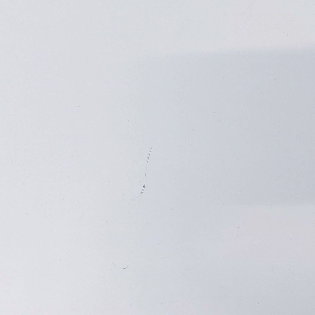 Close-up of white desk surface showing detail and finish quality.