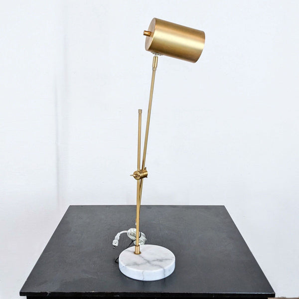 a brass table lamp by [ unused0 ].