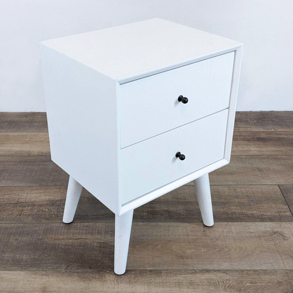 Reperch end table featuring two drawers and sleek black knobs.