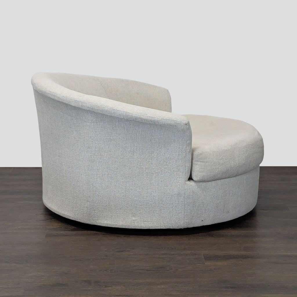 Modern beige boucle lounge chair with curved back, plush seat; stylish and comfortable from Ashley Furniture.