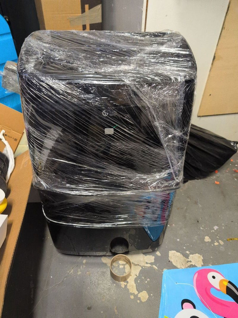 1. Black Reperch AC unit wrapped in plastic film, placed on a concrete floor among assorted items.