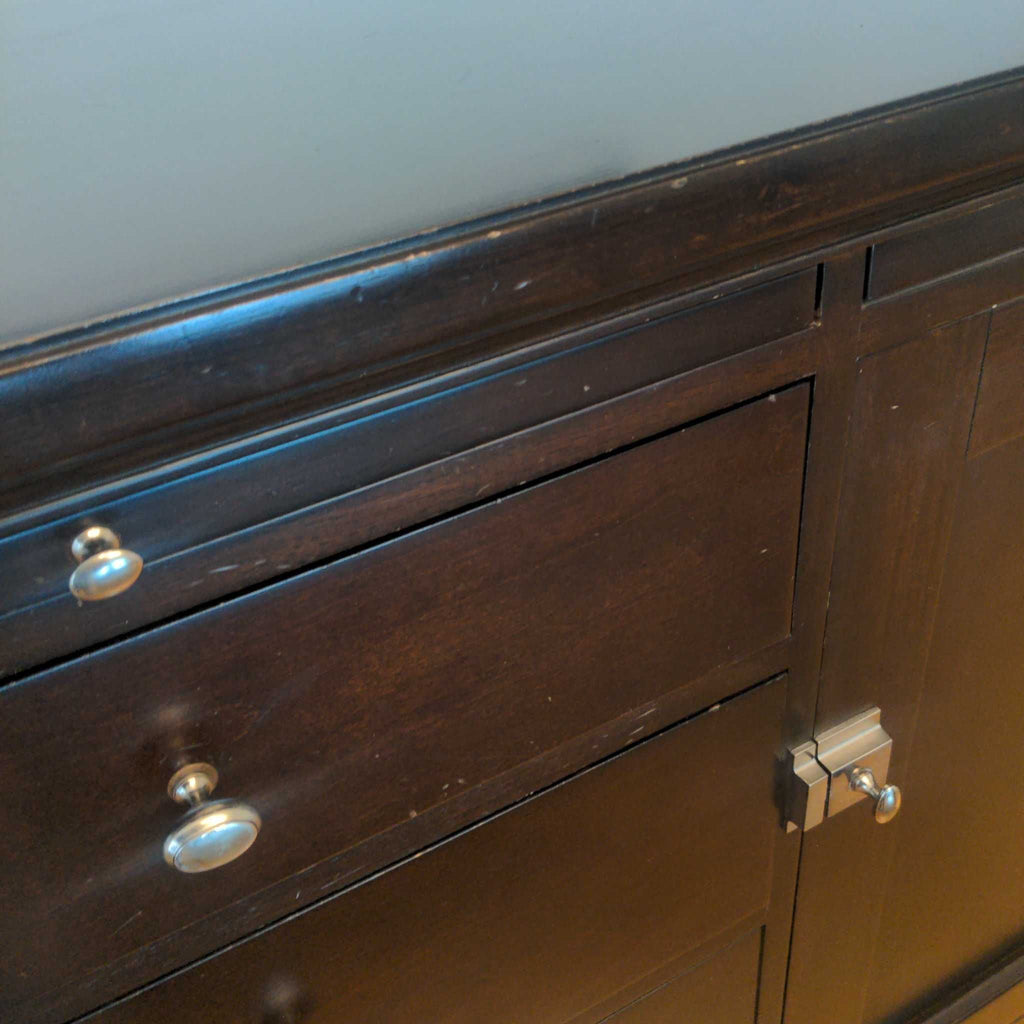 3. Zoomed view of a Bernhardt sideboard corner, highlighting the lock, hardware, and slight wear on the finish.