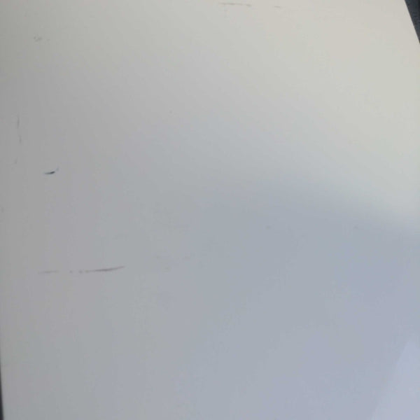 White surface of a Reperch entertainment center showing minor scratches.  