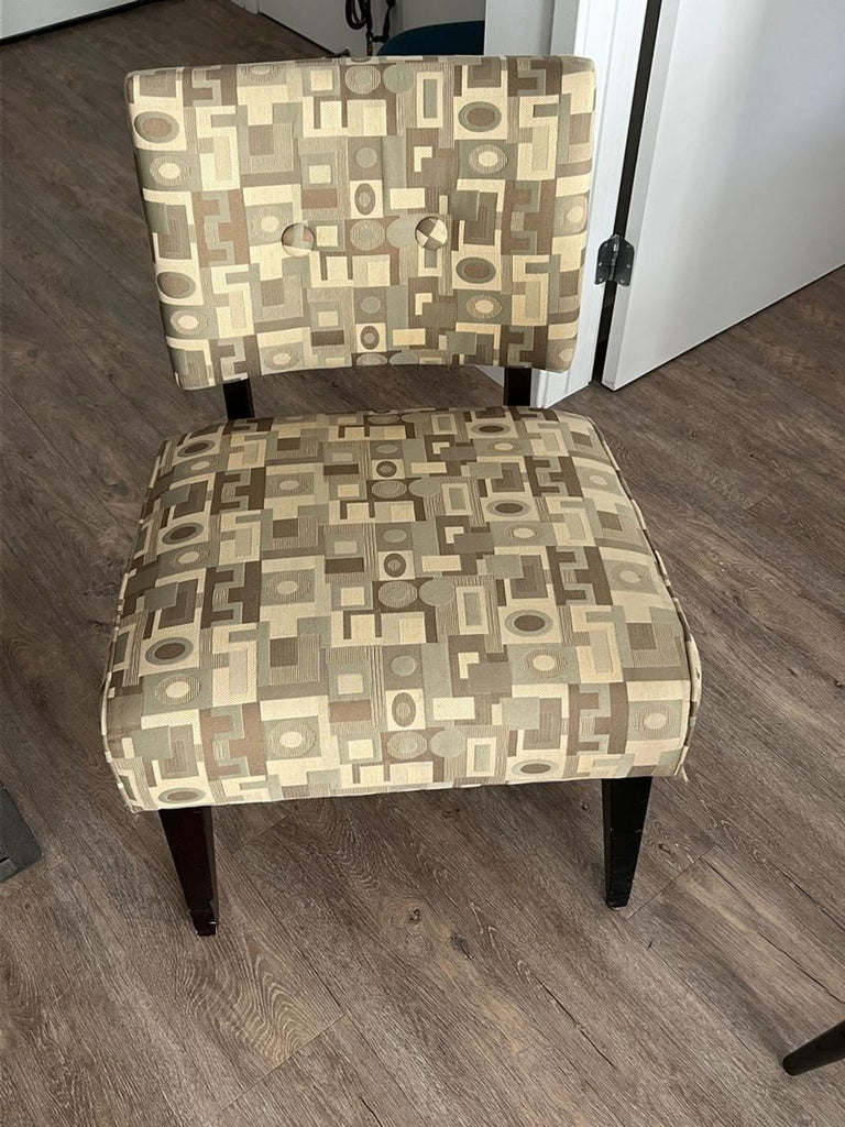 1. Crate & Barrel lounge chair with geometric beige and brown pattern upholstery, dark wood legs, and button-tufted back.