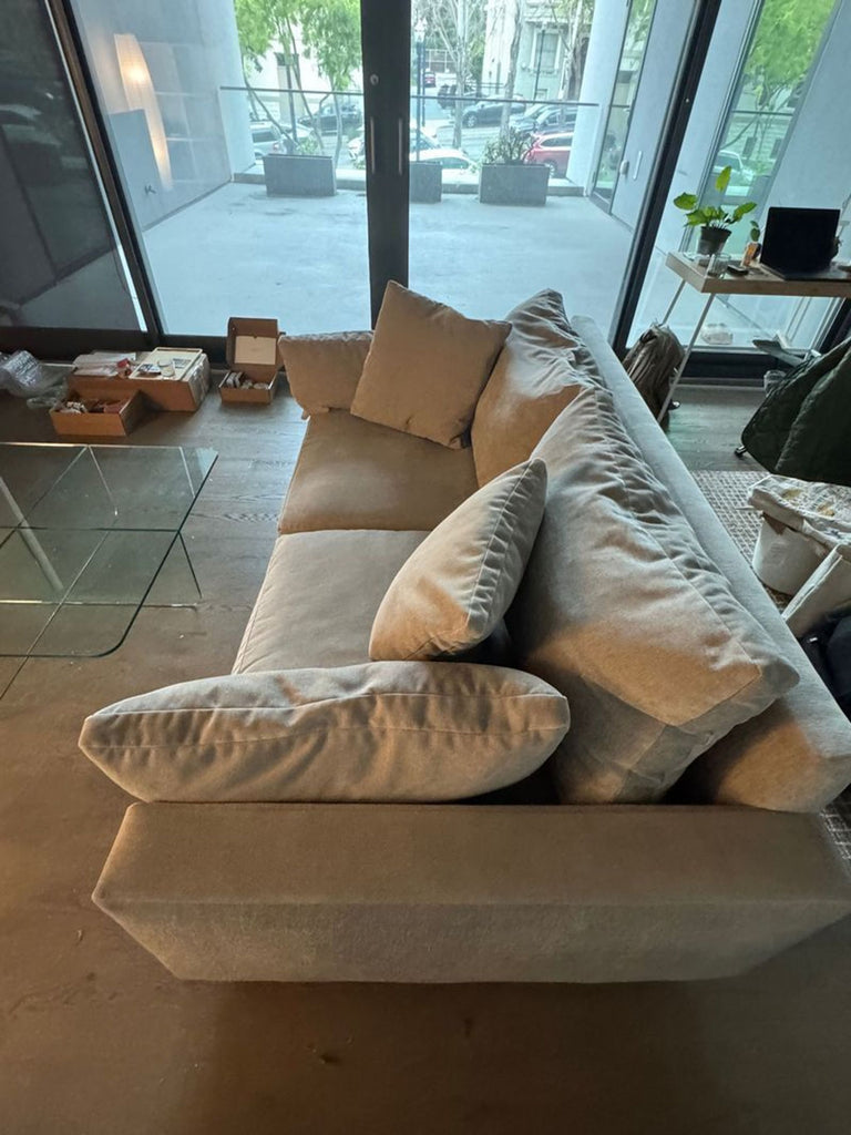 Sleek West Elm 3-seater couch with low arms, tufted cushions, and wooden legs.