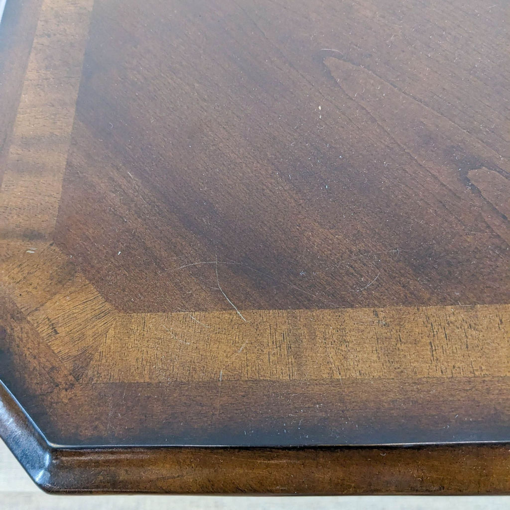 Close-up of Reperch nightstand's inlaid wood finish on top.