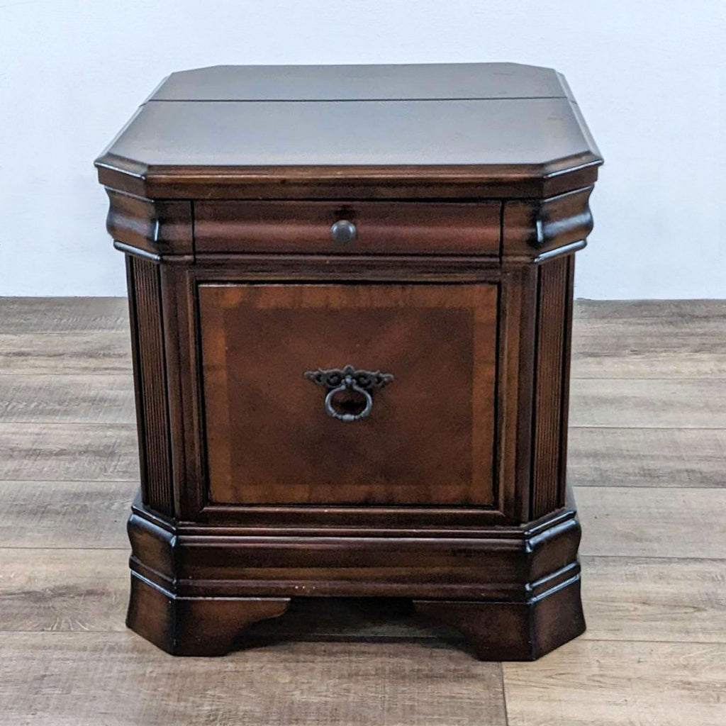 Reperch end table with a single drawer and decorative inlay on top.