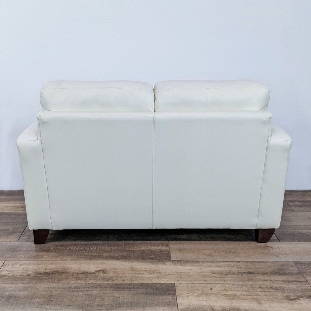3. Rear view of a white contemporary loveseat with simple lines and dark finish feet, category: Loveseat, Sofa By Fancy.