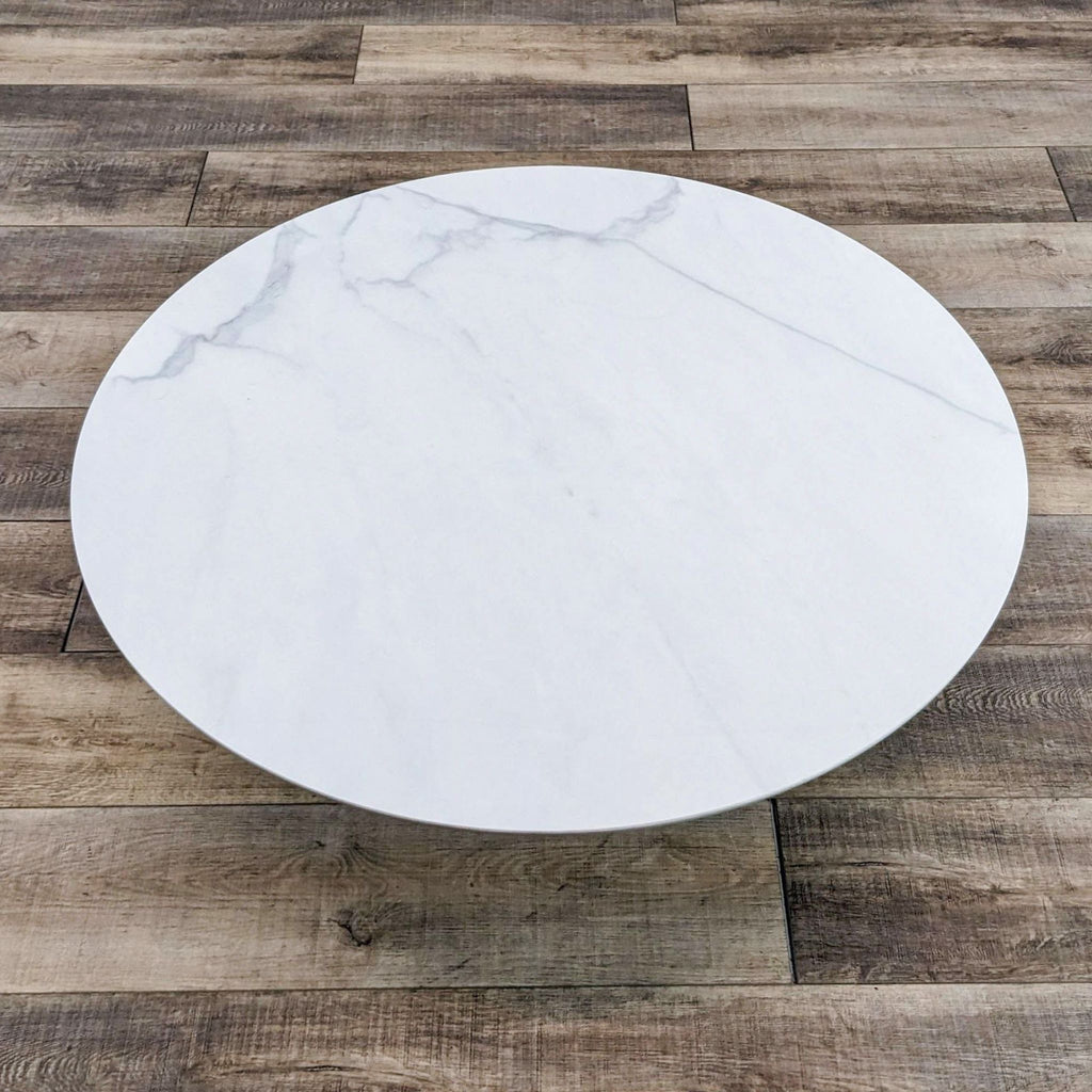 Top view of round coffee table, showing a sleek white surface.