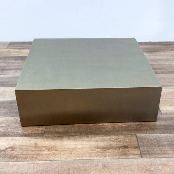 1. Mobital brushed stainless steel coffee table with a modern square design, shown on a wooden floor.