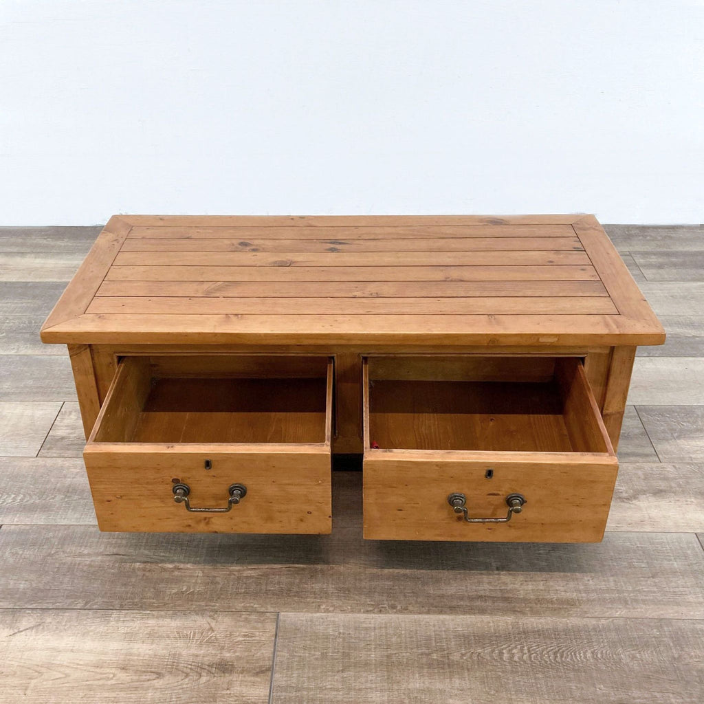Two drawers of the wood coffee table are open, revealing spacious storage.
