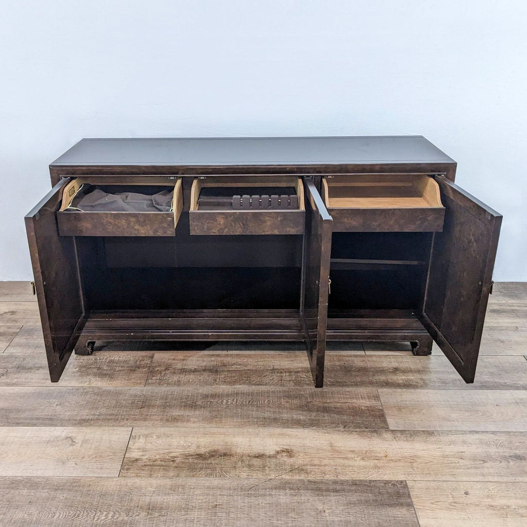 Open John Widdicomb sideboard showing internal drawers and compartments, circa 1960s.