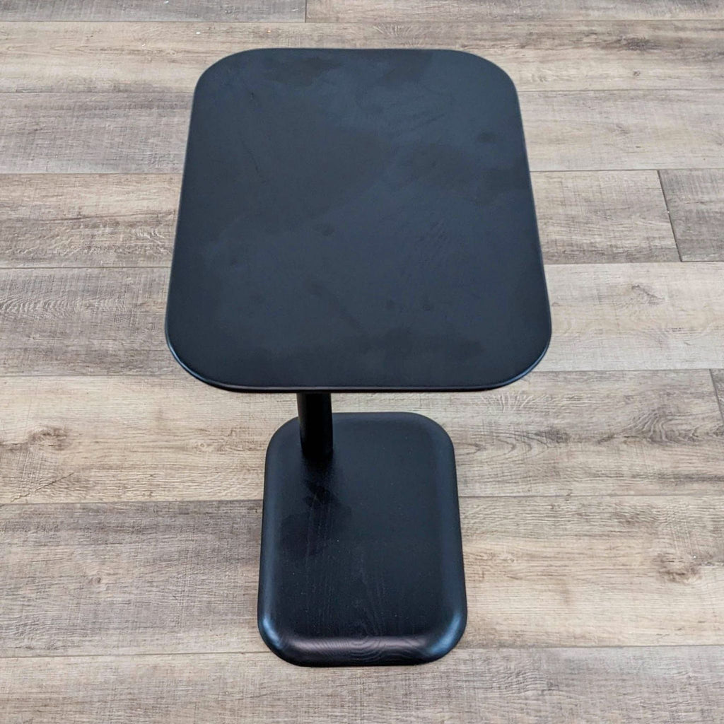 Top view of a black rectangular side table with solid wood construction.  