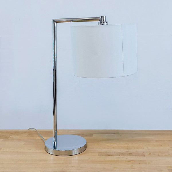 1. Modern lighting fixture with a chrome base and a simple drum-shaped shade.