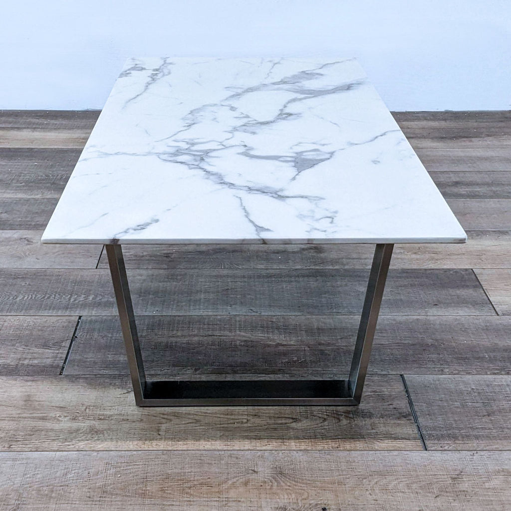 Rectangular marble top table with sleek metal legs.