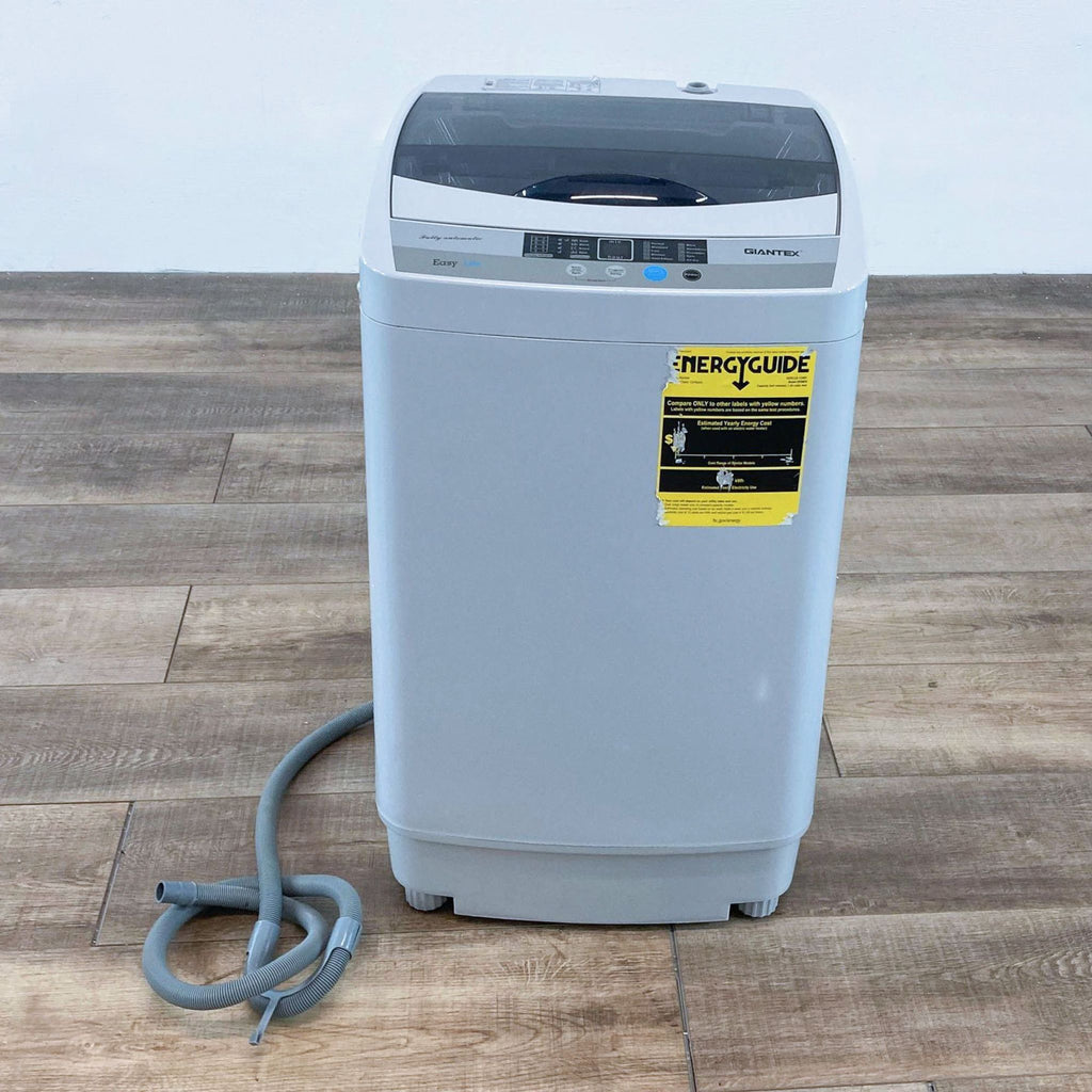 a grey plastic water heater with a yellow cord