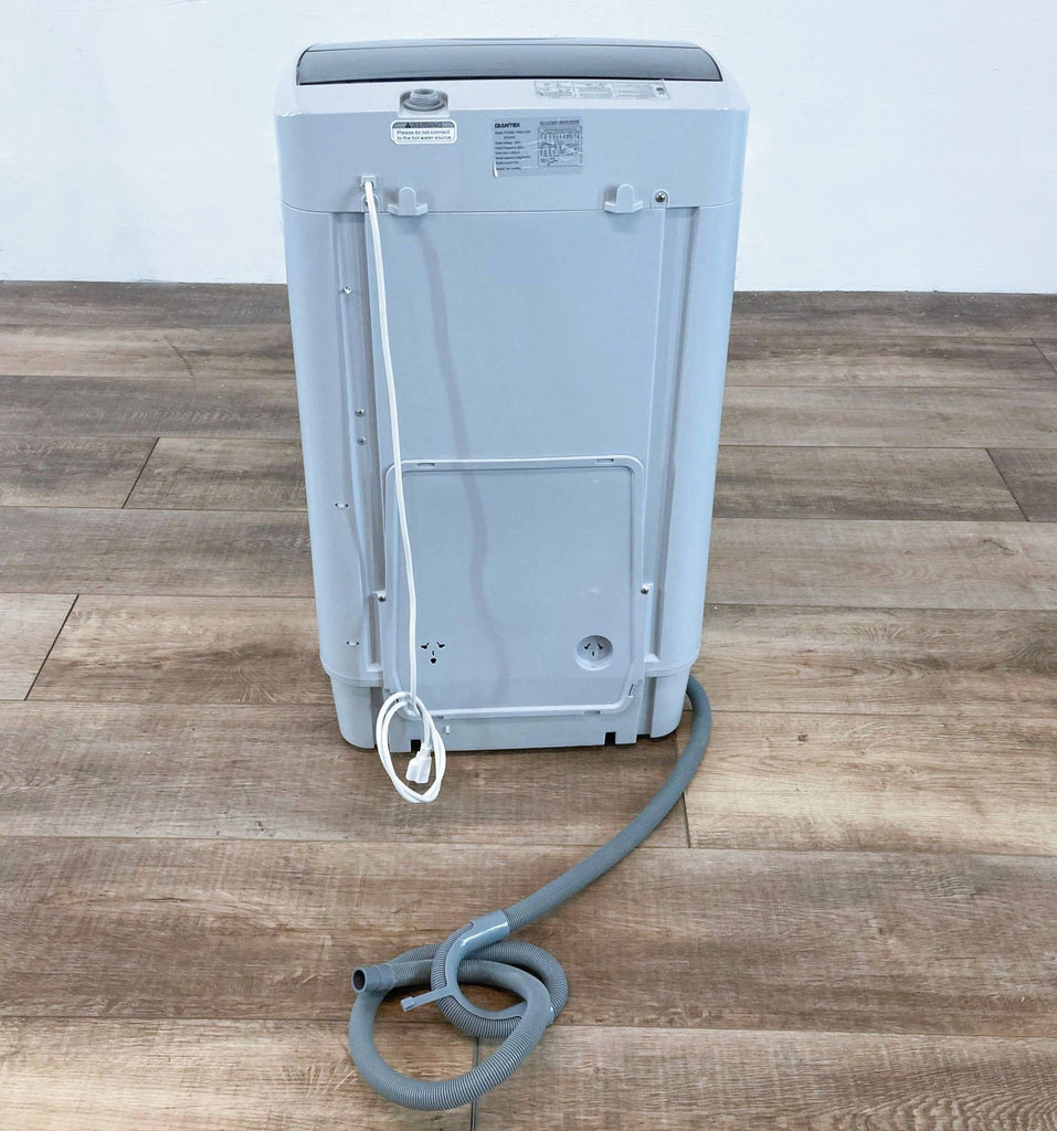 the back of the machine is a grey plastic body with a grey cord.