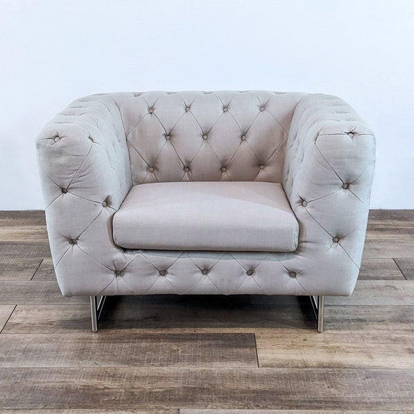 Soft fabric chair with diamond-pattern button tufting and stainless steel legs, from Diamond Sofa Lounge.