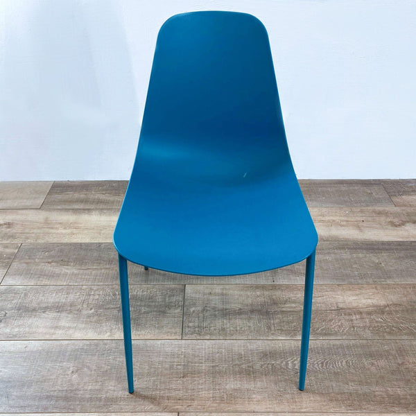 a pair of mid century modern blue plastic chairs