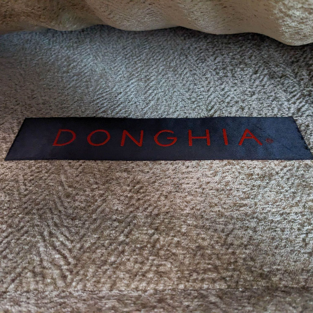 Close-up of Donghia brand label on textured fabric.