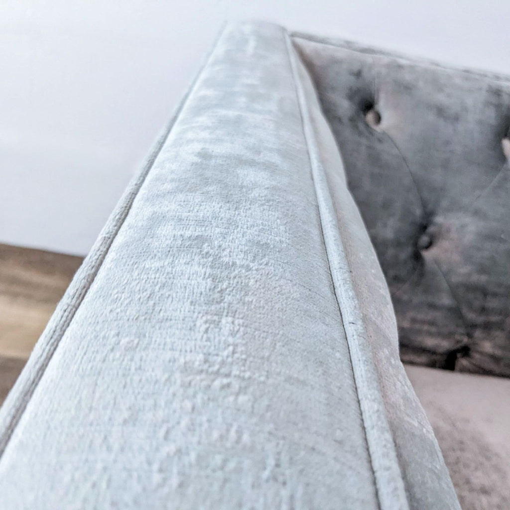 Close-up of soft fabric on a Reperch armchair with button detailing.