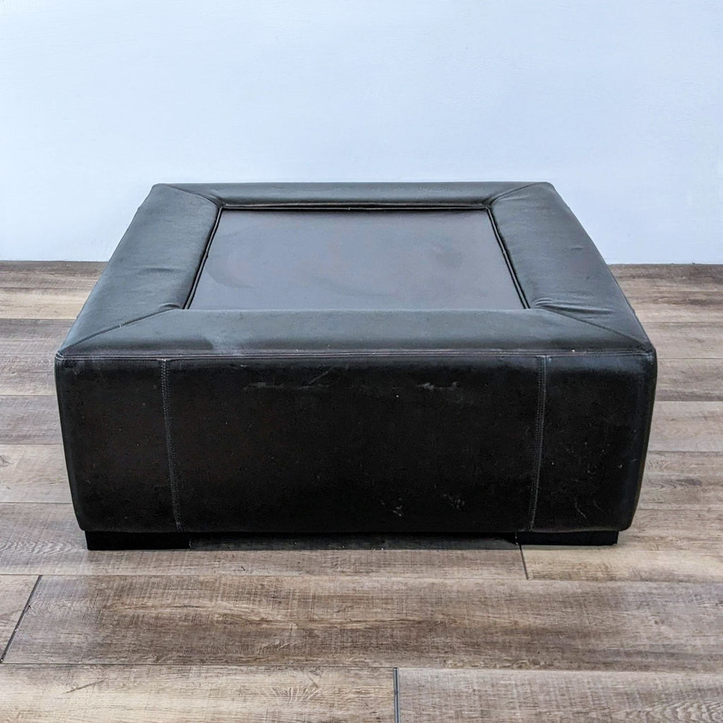 Close-up of Reperch black leather coffee table showing surface details and texture.
