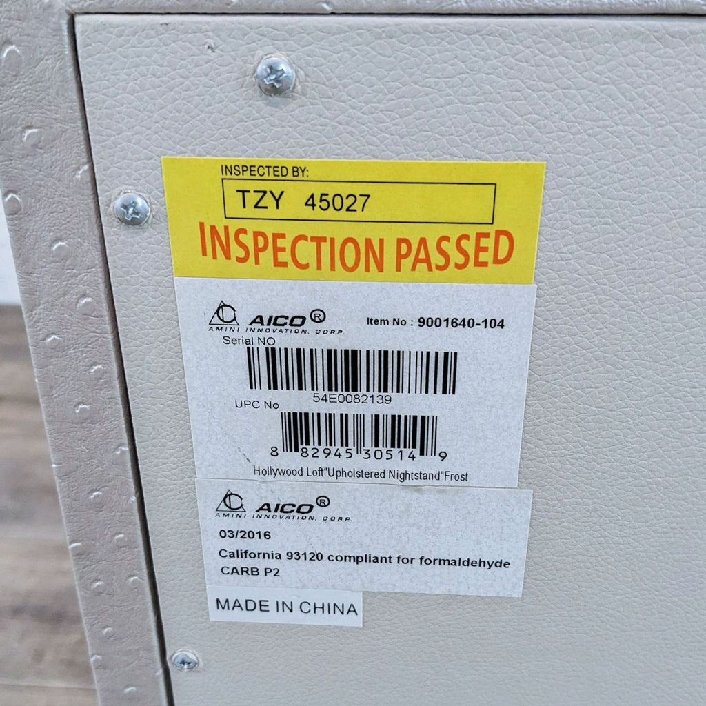 Inspection label on an Amini nightstand, compliant with California standards.