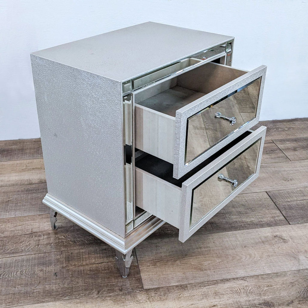 Two open drawers of a nightstand, mirror framed and high-quality finish.
