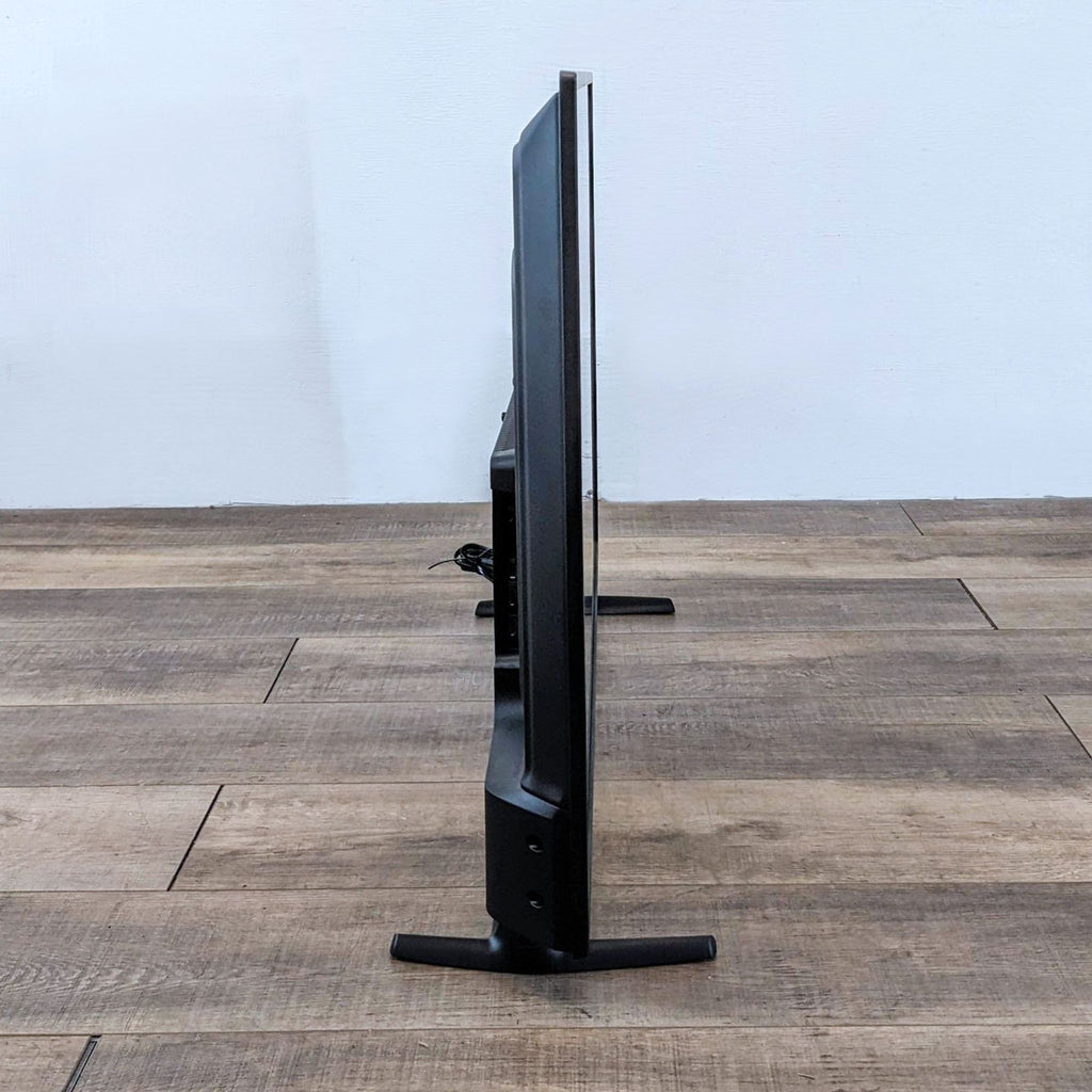 Side view of Insignia TV showcasing its slim profile.