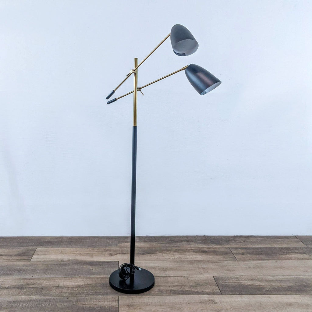 a floor lamp with two adjustable shades.