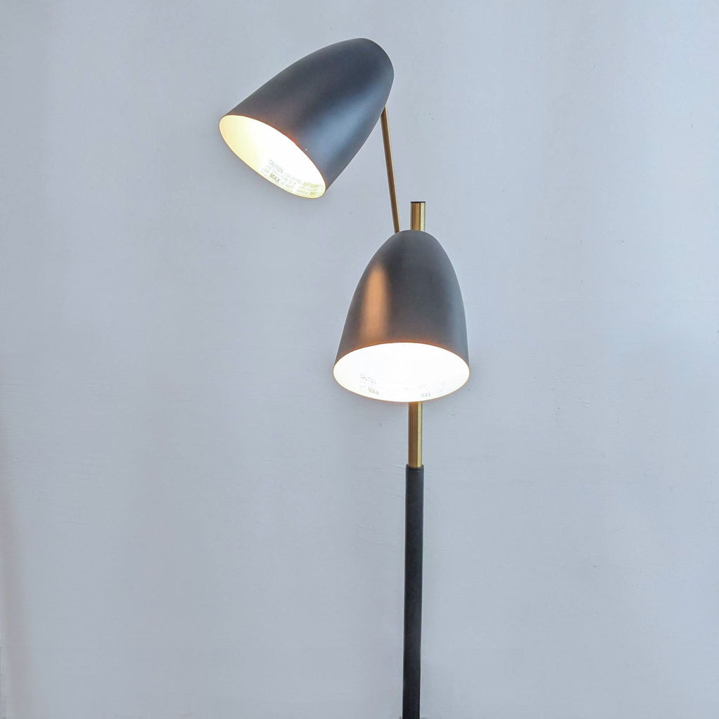 a pair of floor lamps in black and gold.