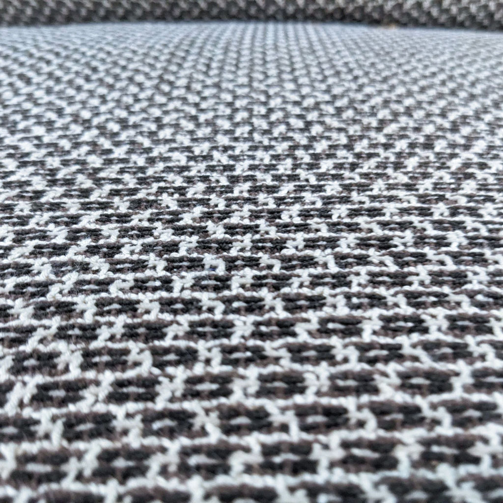 Close-up of small patterned fabric on a sofa.