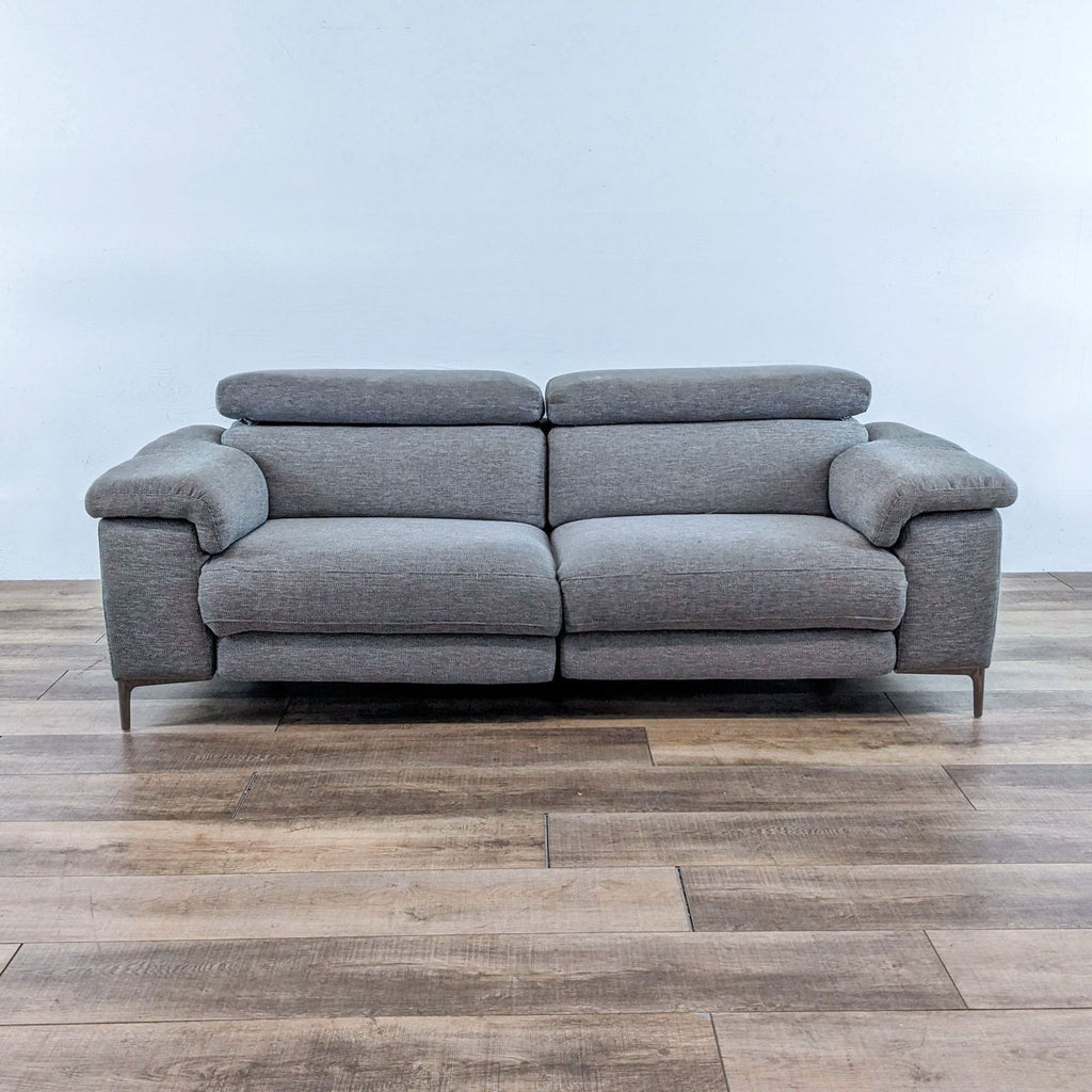 1. Living Space grey 85" dual reclining sofa with adjustable headrests, USB ports, and pillow top arms.