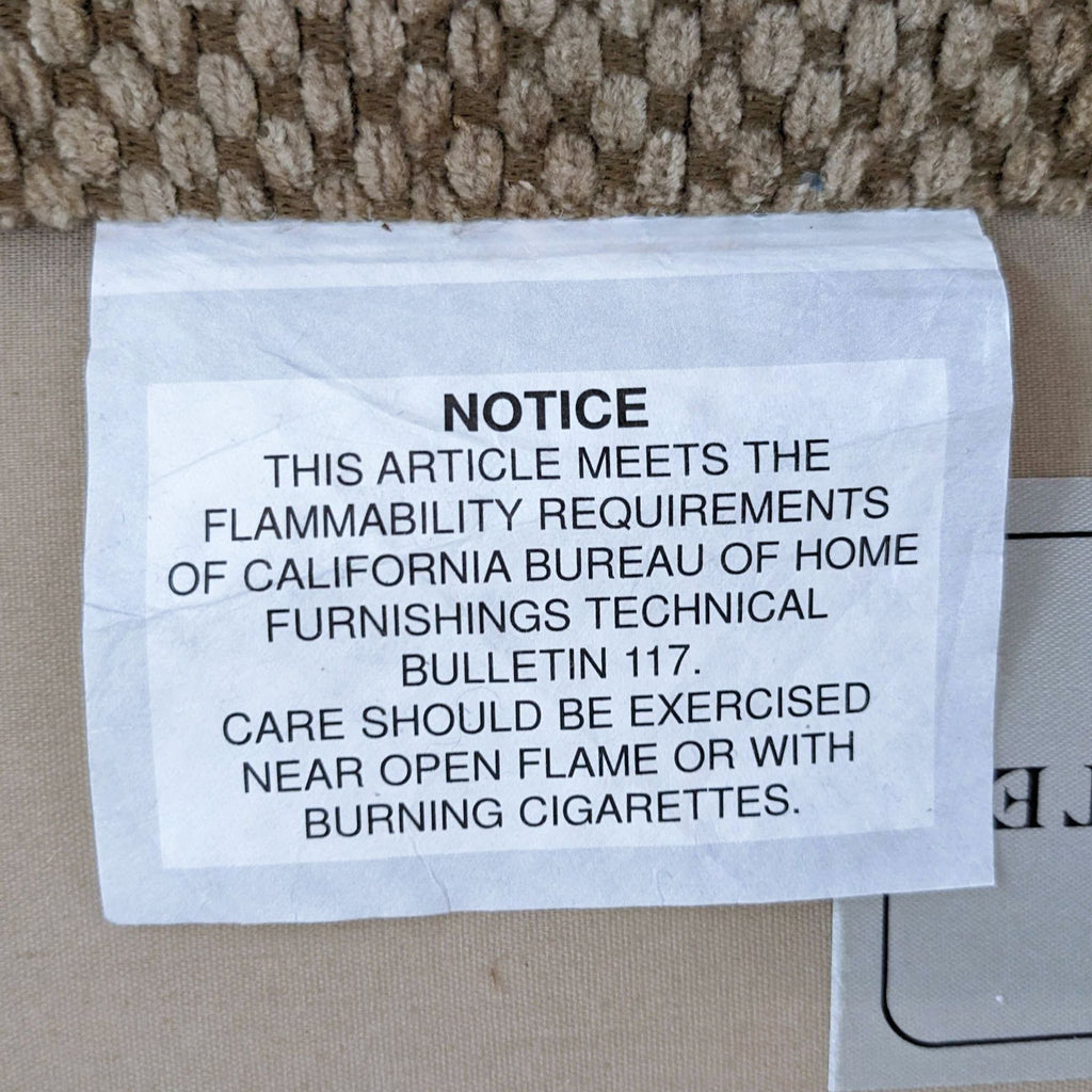 Flammability notice for safety compliance on the sofa.