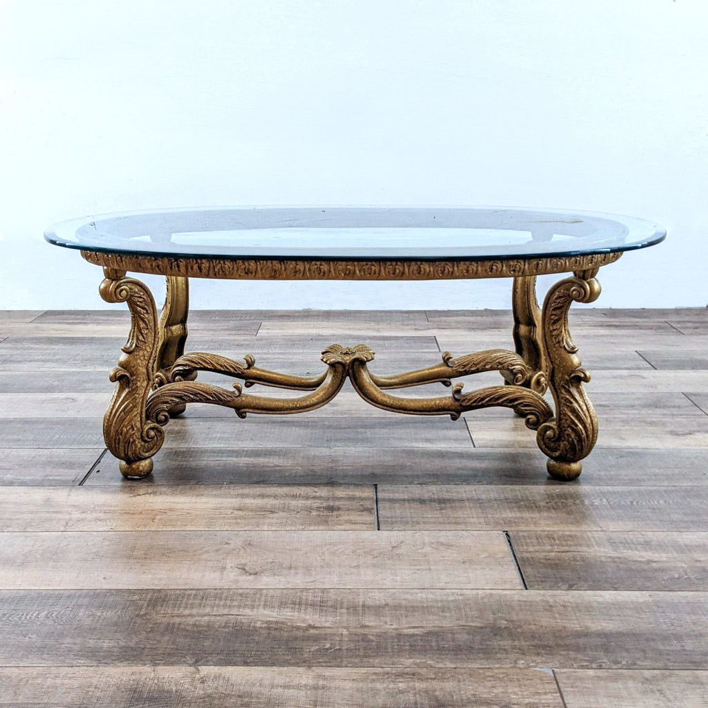 Reperch coffee table with glass top and ornate metal base.  