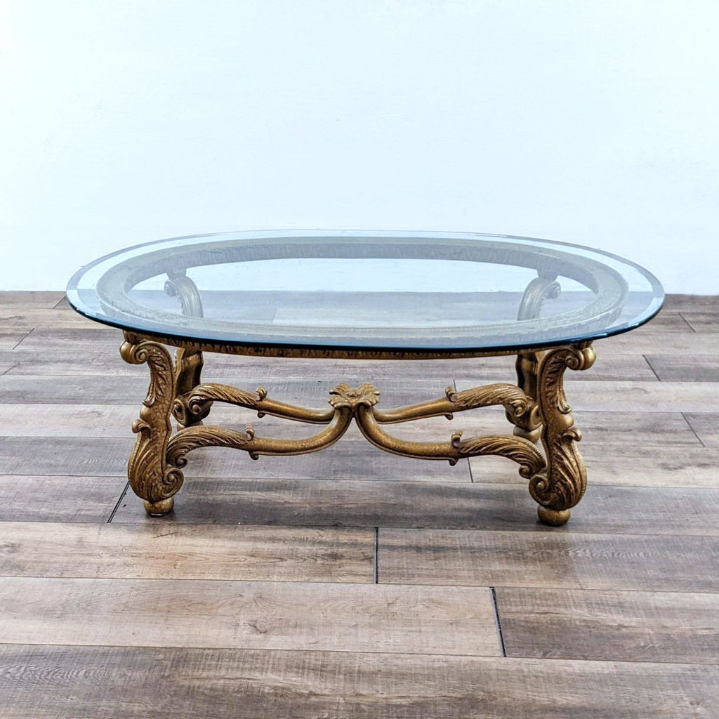 Oval glass top coffee table with elegantly carved legs.  