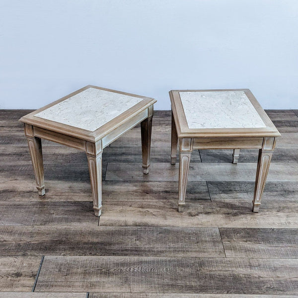Pair of Reperch marble top end tables on wooden floor.