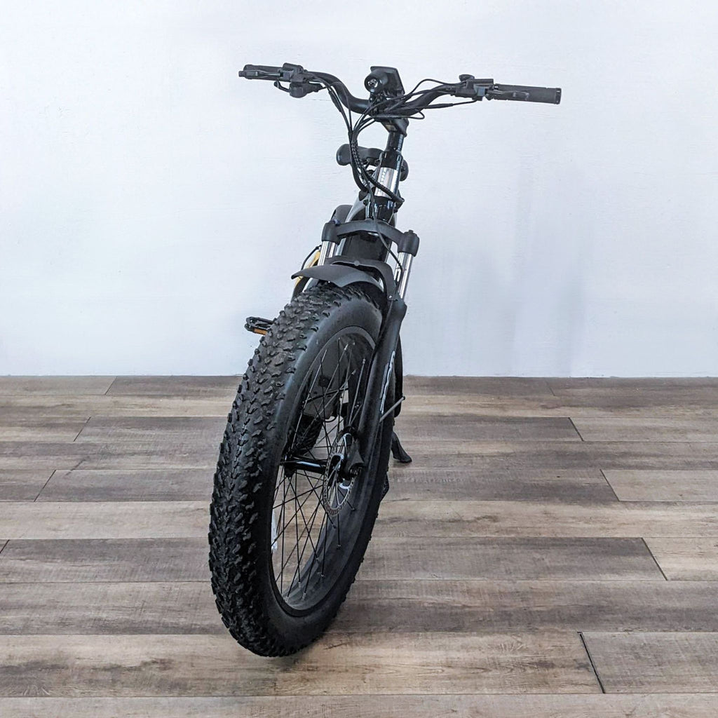 Front view of the Aventon Aventure bike, showcasing its thick treaded tires and handlebars.