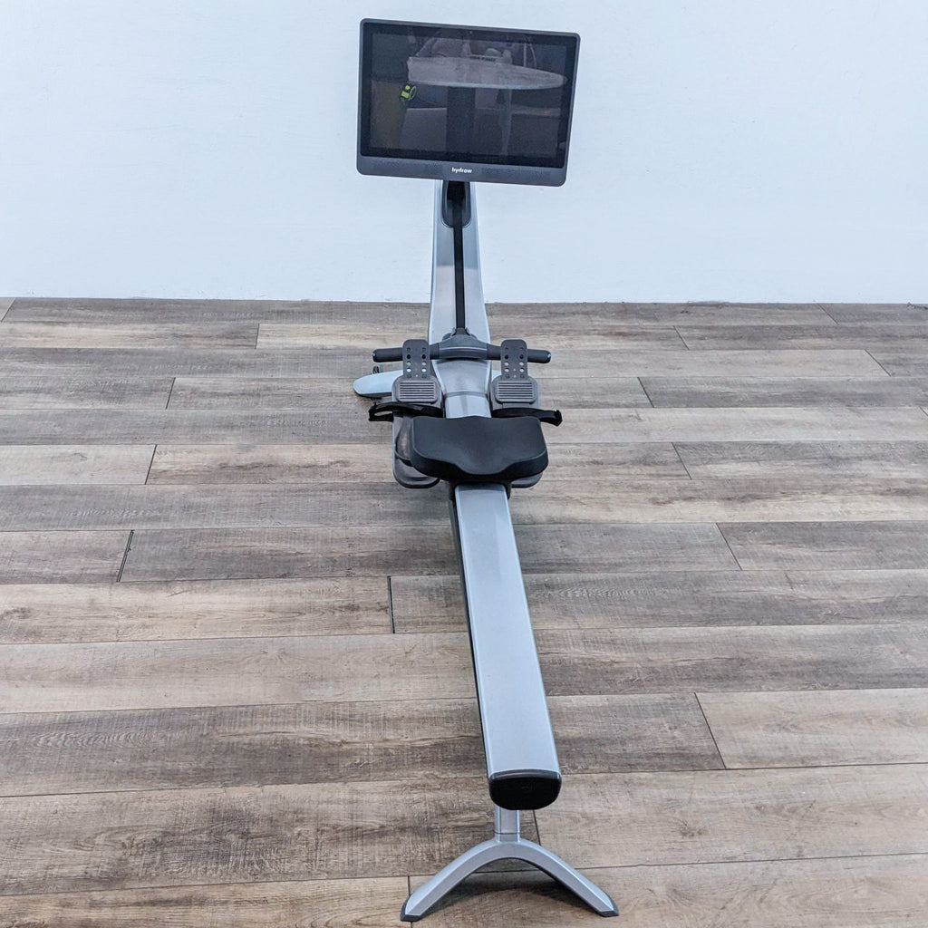Front-facing view of the Hydrow rowing machine and large display.