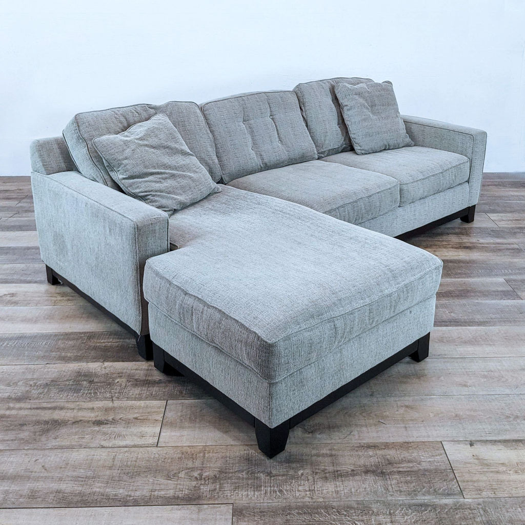 Jonathan Louis sectional with track arms, fabric upholstery, and dark wood feet.