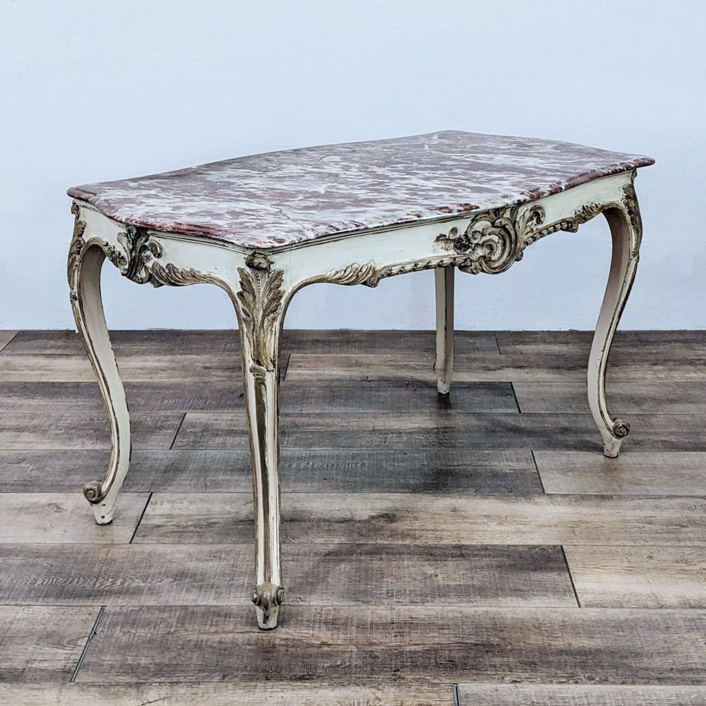 Reperch's classic French-style table featuring intricate carvings and a luxurious marble top.