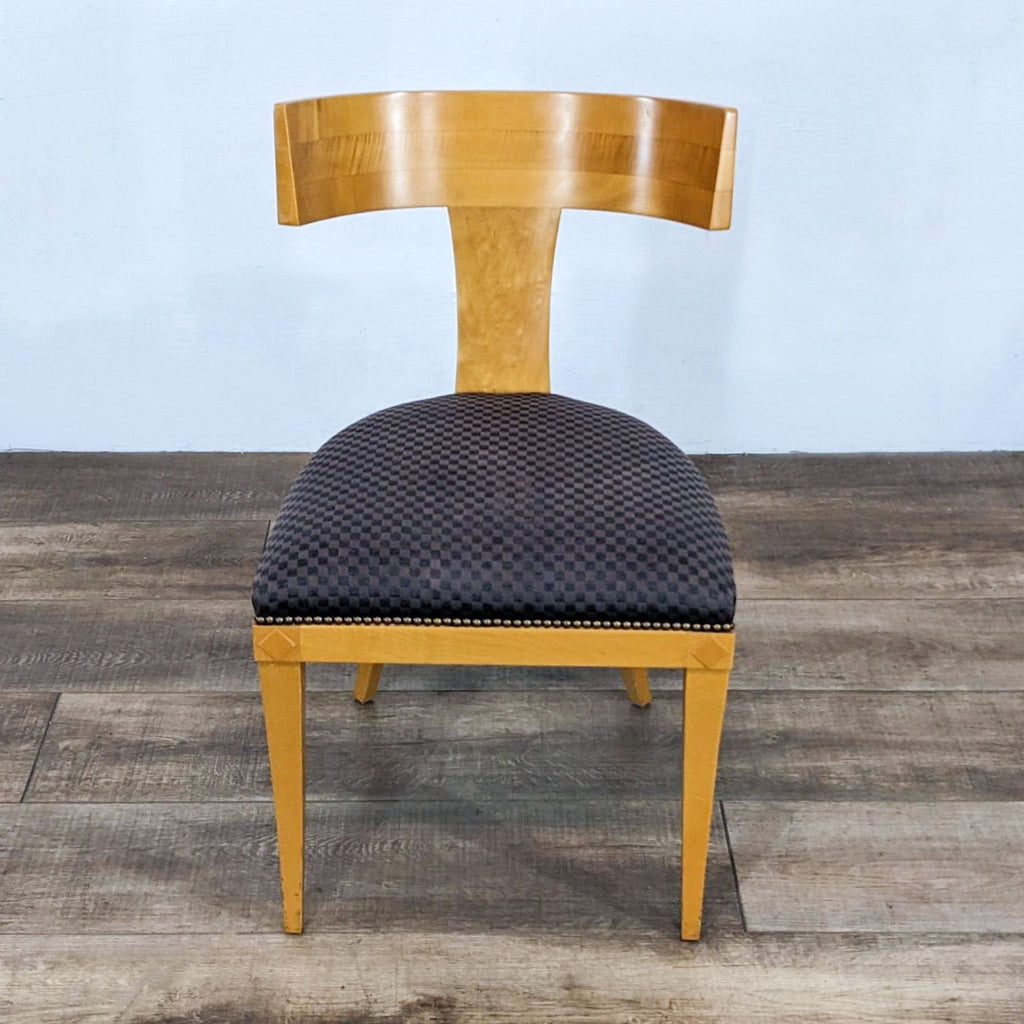 Mid-century modern side chair with curved back and cushioned seat.