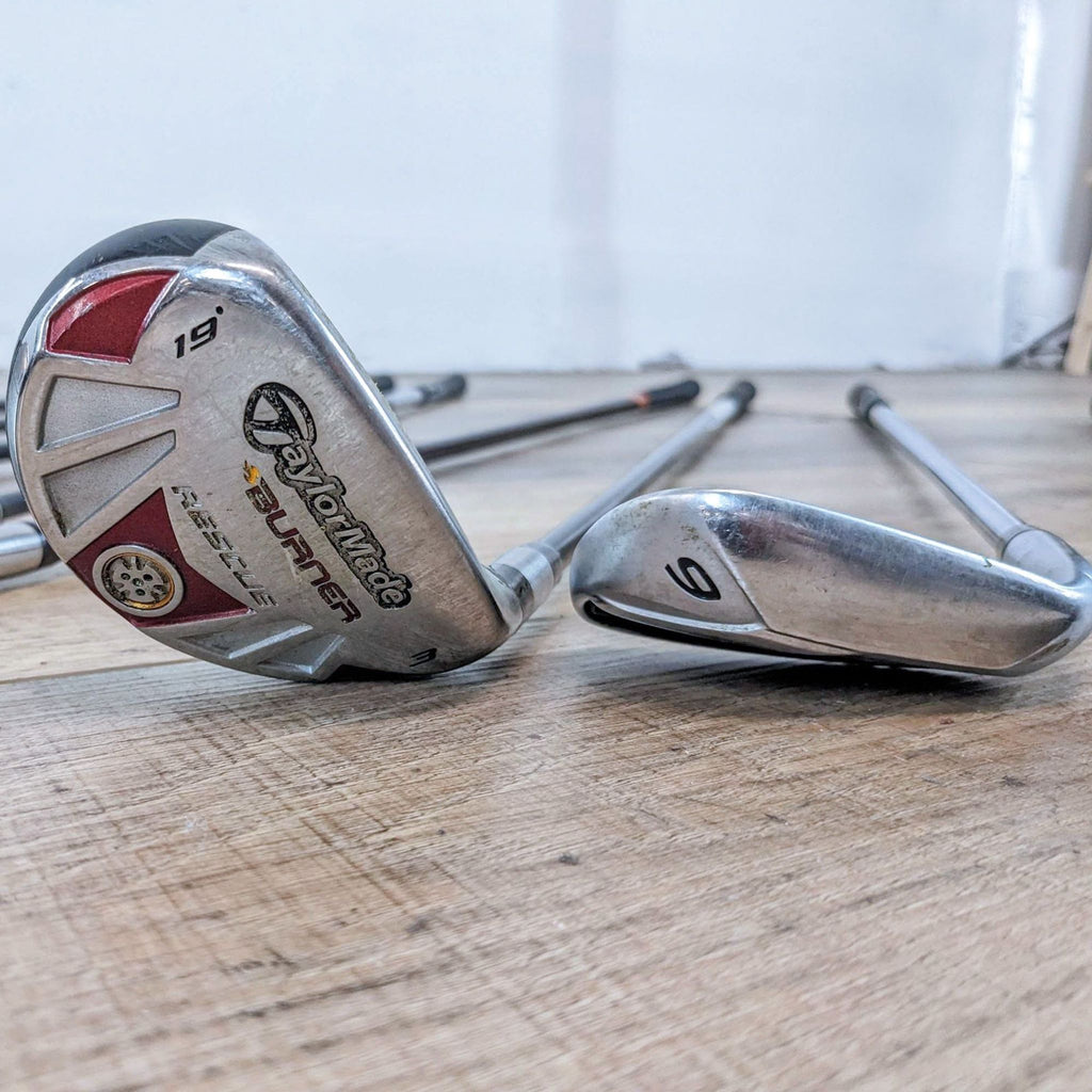 Collection of Reperch golf clubs, including a 9-iron and 19-degree hybrid.