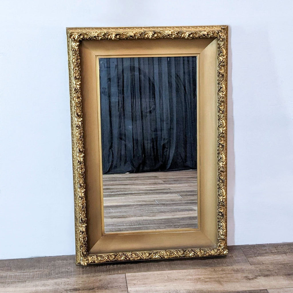 Vintage Gump’s gold giltwood mirror with intricate carved detailing.