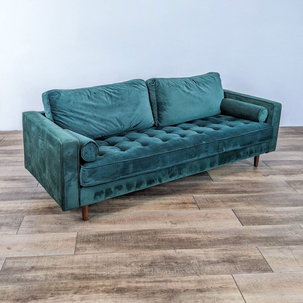 Side view of a green tufted 3-seat Reperch sofa with track arms and bolster pillows.