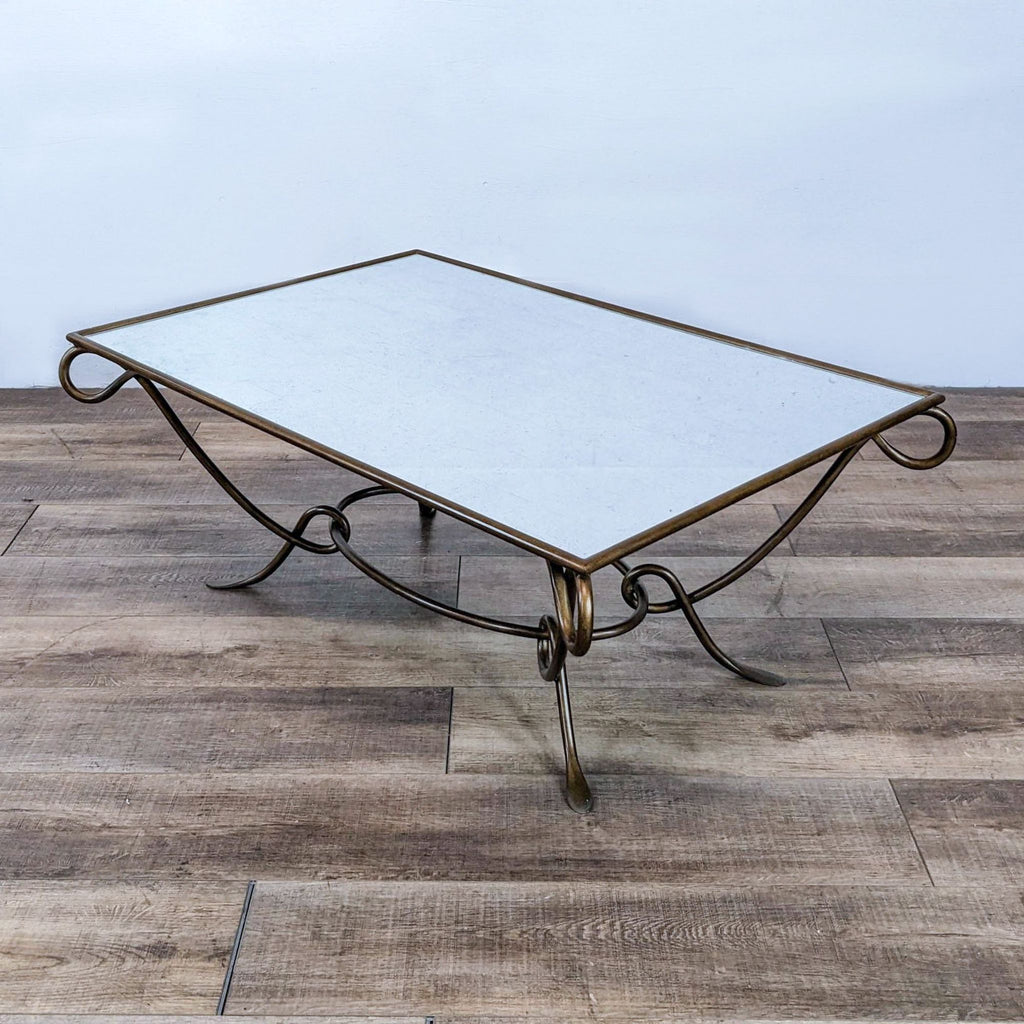 Reperch brand coffee table with a bronze wrought iron base and a sleek glass surface.