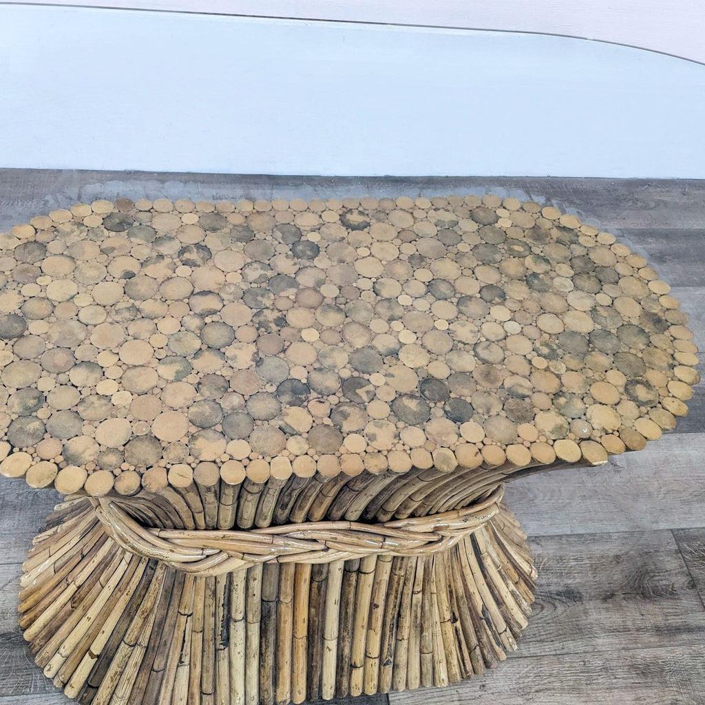 Bamboo-based dining table by Reperch with a beveled oval glass top, revealing detailed craftsmanship.