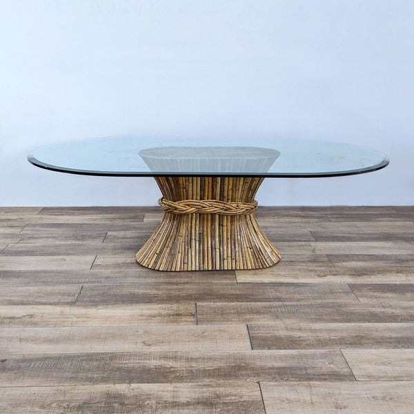 Oval glass dining table with a bamboo base designed like a sheaf of wheat from Reperch.