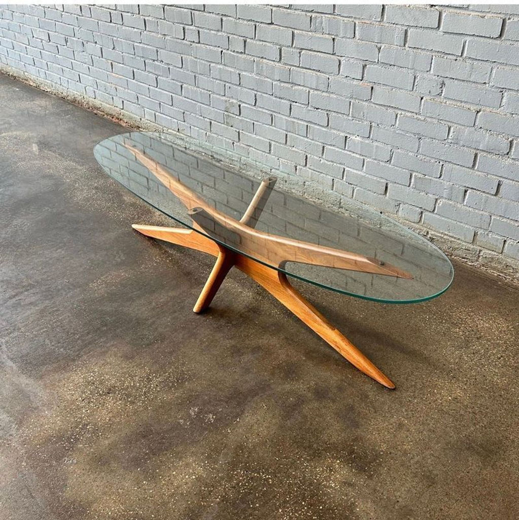 Top view of an Adrian Pearsall coffee table featuring a sculptural wooden base and an elongated glass surface.