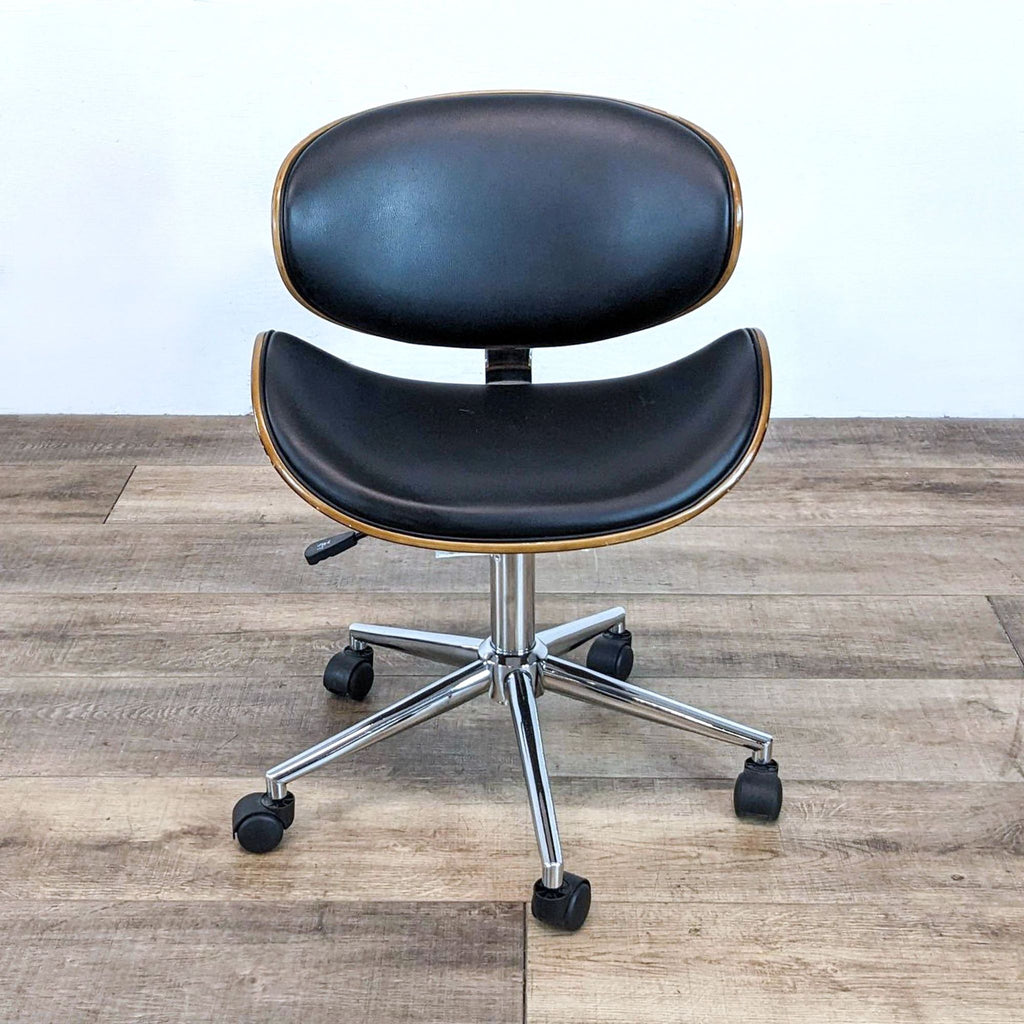 Curved wood task chair with faux leather cushions and chrome base.